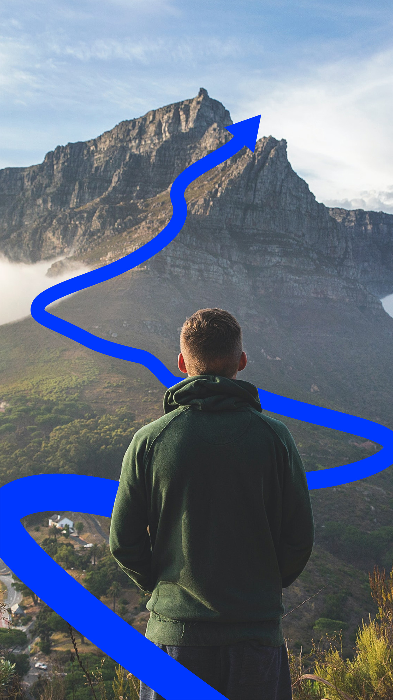 A man stands looking out at a mountain ahead of him. A blue arrow winds around him tracing his future path up a mountain.